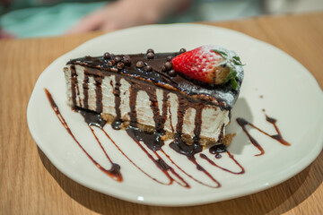 close-up of a cake with strawberries on a plate in a cafe