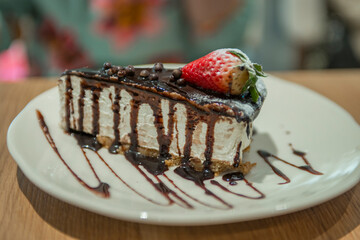 close-up of a cake with strawberries on a plate in a cafe
