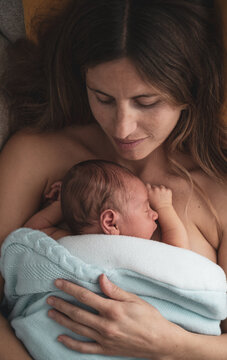 mother with her baby on her breast. concept of motherhood, newborn, care, protection, love
