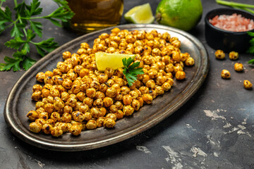 fried chickpeas on a dark background. Traditional Indian cuisine. Tasty vegetarian and vegan chickpea snack. banner, menu, recipe place for text, top view