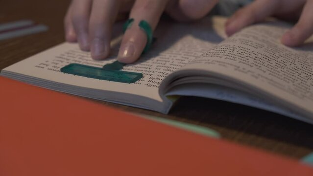 Reading tools for dyslexia. Child reading book using finger focus highlighter dyslexia tool. Education, learning disability, reading difficulties concept