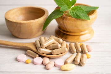 Alternative medicine herbal organic capsule with vitamin E omega 3 fish oil, mineral, drug with herbs leaf natural supplements for healthy good life.
