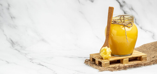 Ghee clarified butter. Bio Ayurveda Lactose free high quality butter on a light background. place for text, Long banner format