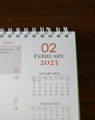 Top view of 2023 calendar. First page "January". Selective focus shot of a calendar, focused on "01, January, 2023".