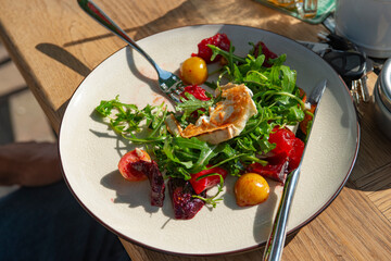 close-up of home cooked  salad with  vegetable ,greens and goat cheese