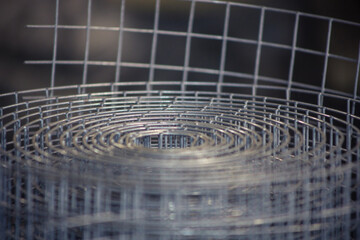Metal mesh close-up, metal background slightly blurred. Metal grid for welding. Metal construction...