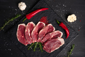 Raw meat, steak on black background