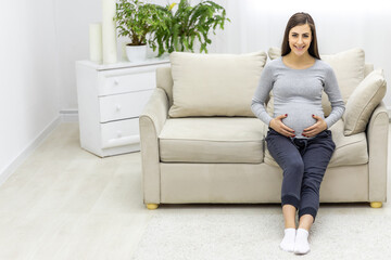 Photo of pregnant woman hugging her stomach