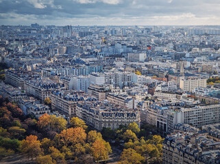 Obraz premium Paris cityscape view from the Eiffel tower height, France. Fall season scene with colored trees