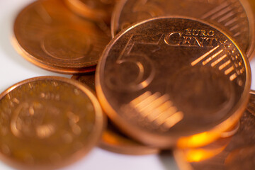A pile of change on the table. Many euro coins in one stack. The concept of a monetary crisis in the country. Selective soft focus