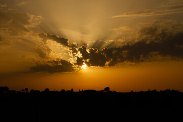 sunset over the village with beautiful clouds