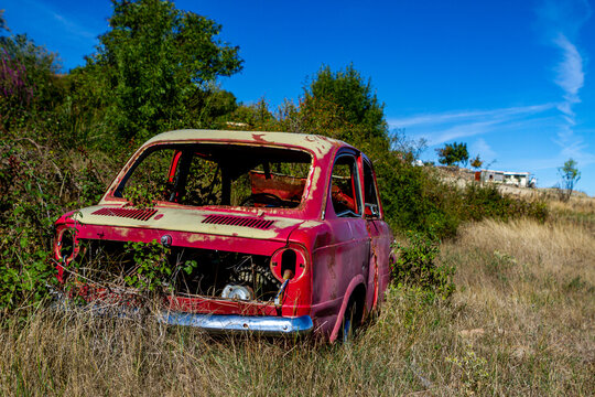 old abandoned red car in the countryside