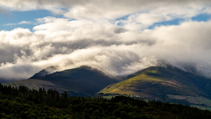 Fototapeta na wymiar clouds over the green mountains