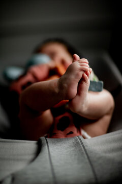 Vertical photo of small baby feet