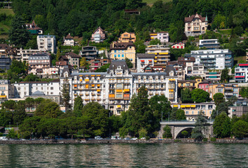 Fototapeta na wymiar Montreux, Switzerland - July 14, 2022: Cityscape of tourist resort of Montreux with luxury hotels and riviera.