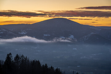 Winter sunset in Moravian-Silesian Beskids in Czech Republic, view of the Ostry peak with elevation of 1045 meters - obrazy, fototapety, plakaty