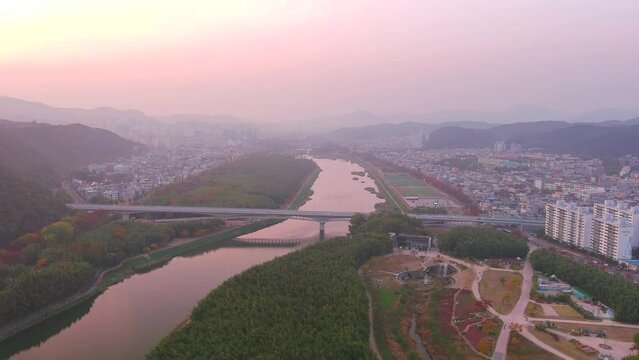 Ulsan: Aerial view of Metropolitan City in South Korea at sunset, trees in autumn colors, Taehwagang National Garden with famous bamboo forest - landscape panorama of Eastern Asia from above