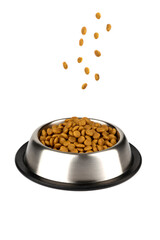 Pieces of dry food for cats and dogs fall into a bowl on a white background.