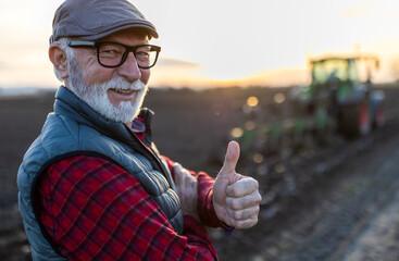 Mature farmer showing ok sign in field © Budimir Jevtic