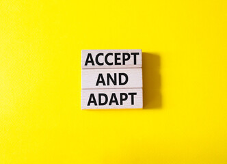 Accept or adapt symbol. Wooden blocks with words Accept and adapt. Beautiful yellow background. Business and Accept and adapt concept. Copy space.