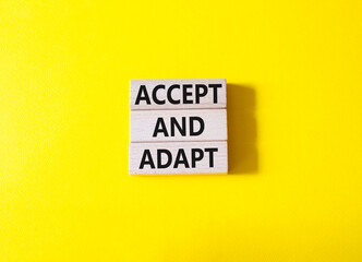 Accept or adapt symbol. Wooden blocks with words Accept and adapt. Beautiful yellow background....