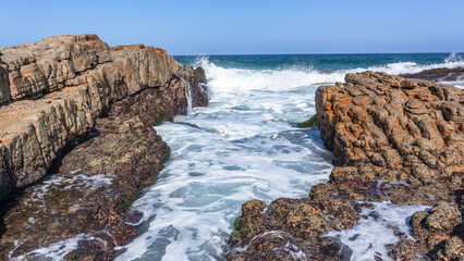 Beach Rocks Gully Crevice Ocean Wave Sea Water Horizon Wash Close-Up Photograph.