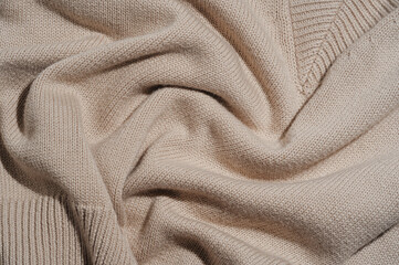 Flat lay of knitted cotton beige sleeveless top