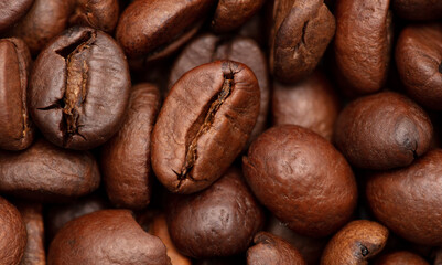 Grains of black coffee as a background.