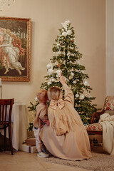 mother and son decorate the Christmas tree