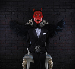 devil with black wings on the throne