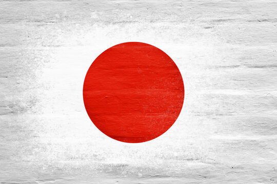 Flag of Japan. Flag painted on a white plastered brick wall. Brick background. Copy space. Textured background