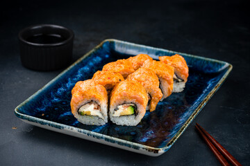 Set of sushi rolls with salmon tartare, smoked eel, cream cheese and avocado.