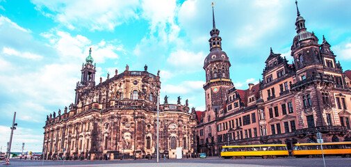 Fototapeta na wymiar Beautiful landscape with yellow trams in the background Catholic Court Church (Katholische Hofkirche) in the center of old town in Dresden, Germany