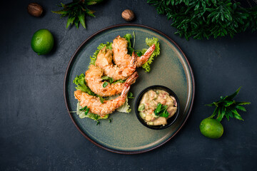 Asian food fried shrimp in almond flakes with lettuce and vegetable dressing.