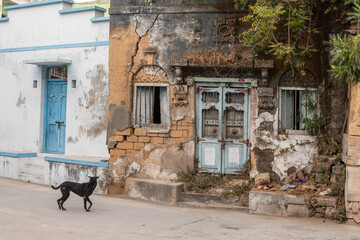 An old ruined dilapidated wooden door of a broken Portuguese era house in the town of Diu.