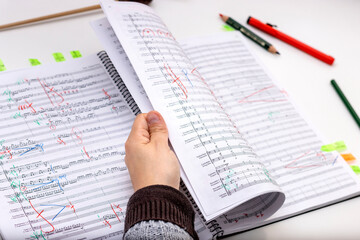 Orchestra conductor studying the scores of her next works