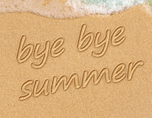 closeup of a  text bye, bye summer written in it, on the sand of a beach