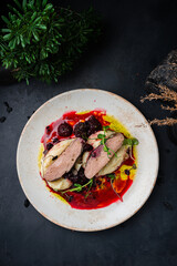 Duck fillet with mashed potatoes and blackberry sauce.