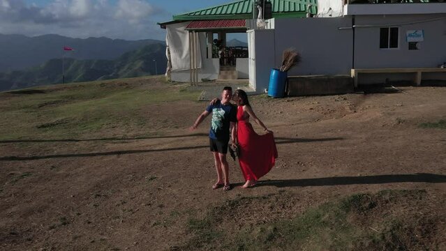 Drone flight away from walking couple at  Redonda Montana at Dominican Republic, Famous hill, touristic place in the morning