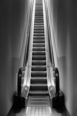 Black and white photo of a single escalator
