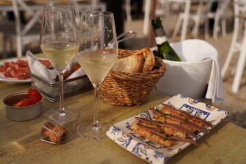 Naklejka na ściany i meble Mediterranean lunch or dinner - cava sparkling wine and traditional spanish snacks - hamon, anchovies, pan con tomate.