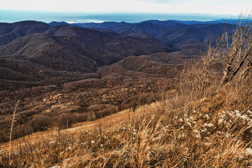 Stunning view from the top of Mount Peus in the Northwest Caucasus. Stunning view of the mountain landscape from a height. View from a height of 1000 m to the peaks of the Caucasus. 