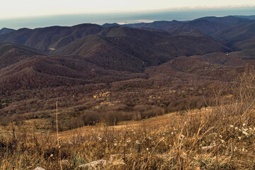 View from a height of 1000 m to the peaks of the Caucasus. Stunning view from the top of Mount Peus in the Northwest Caucasus. Stunning view of the mountain landscape from a height.