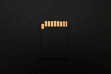 SD memory card. Concept. Black background, slate.