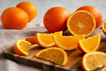 Raw Organic Orange Fruit on a white wooden background, side view.