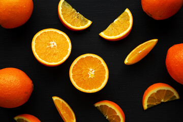 Raw Organic Orange Fruit on a black background, top view. Flat lay, overhead, from above.