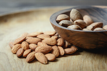 Peeled raw almonds on a wooden plate and almonds in a shell in a wooden bowl on a wooden background.
