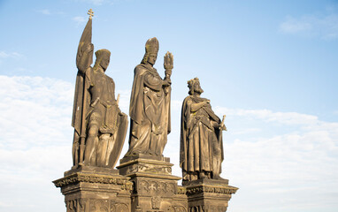 Fototapeta na wymiar statue of three saints on charles bridge in prague from the front in blue sky day