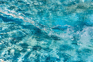 jet of water falling on the surface of a swimming pool