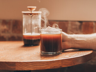 Steaming cup of hot coffee in cafe